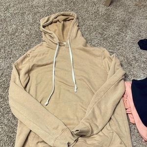 Used has three small pens stands oversized hoodie.